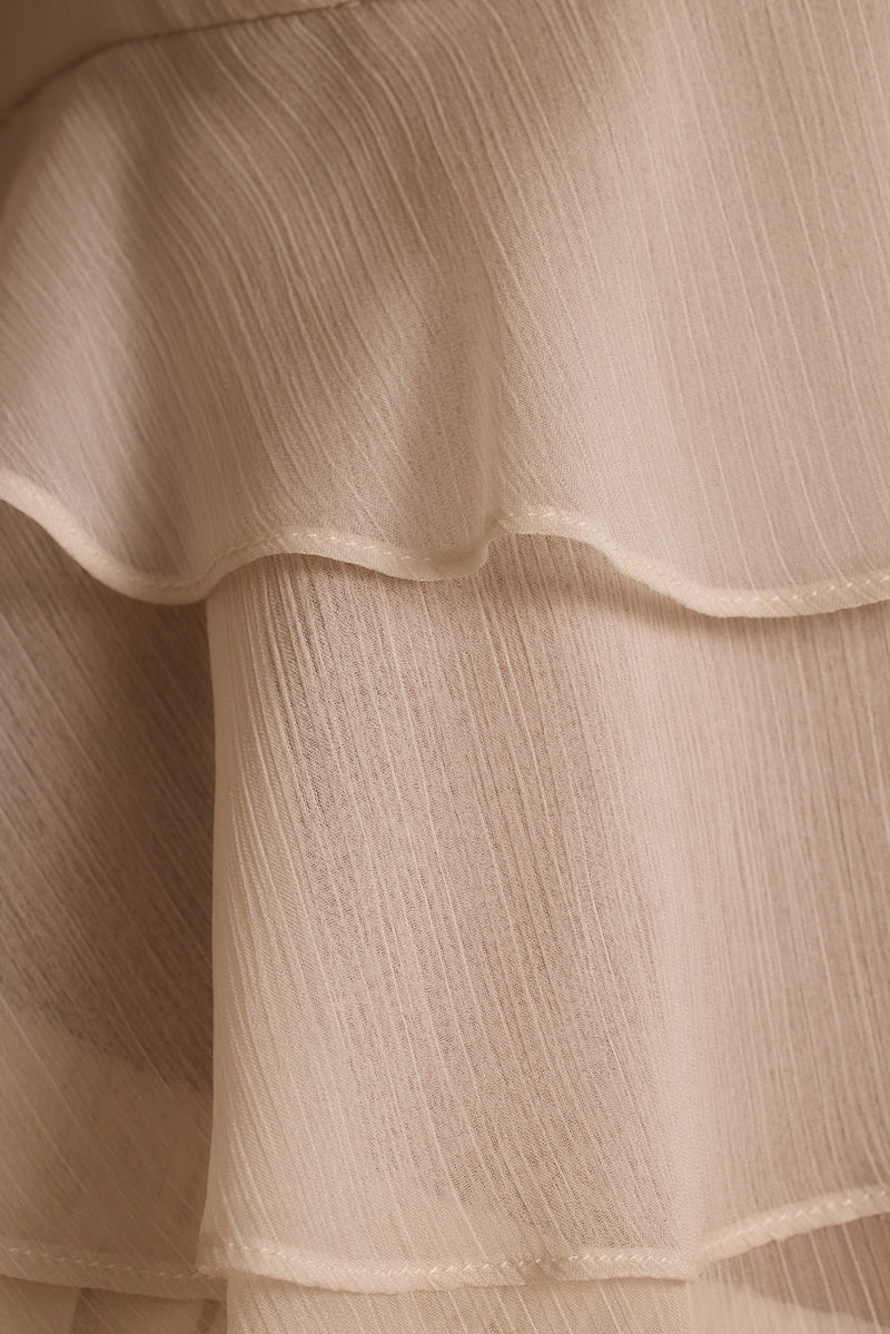 Close-up of tiered ruffles and crinkle texture on the cream Alana resort wear blouse.