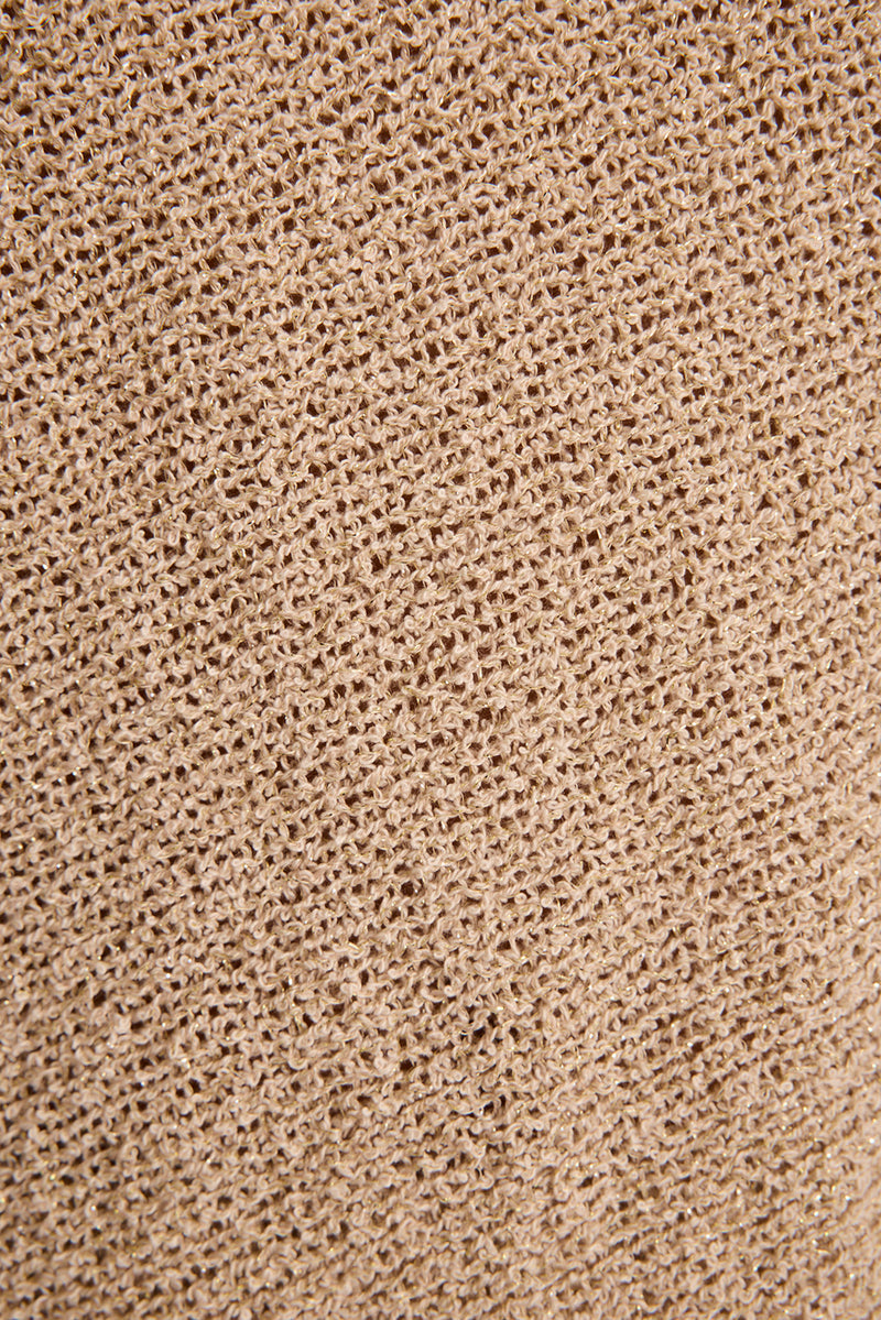 Close-up of stretchy metallic gold knit fabric used for the Avaiana festival shorts.