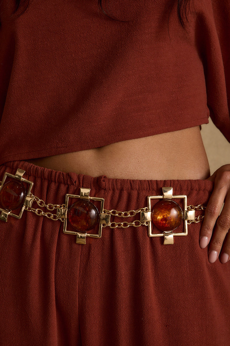Coralli Amber Stone Statement Belt paired with complementary accessories for a polished look.