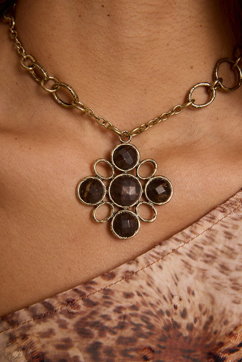 Delphine Gold Pendant Necklace shown from a different angle, highlighting the metalwork details.