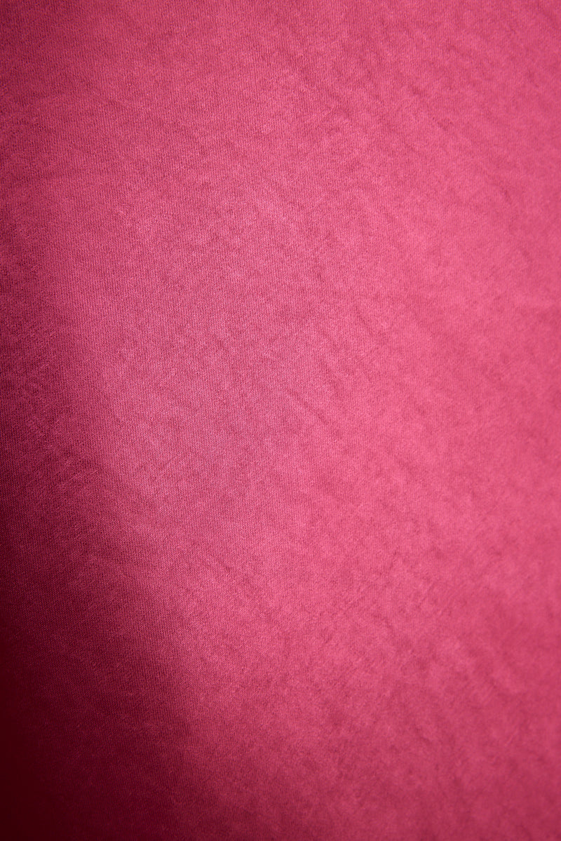 Close-up of fuchsia satin fabric showing the sleek sheen of the Mirabella maxi dress.