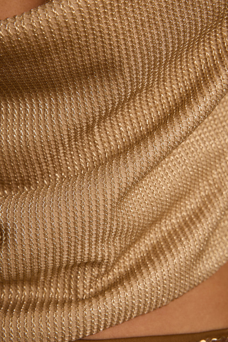 Close-up of the Solene halter top's shimmering gold lurex knit and draped cowl neckline.
