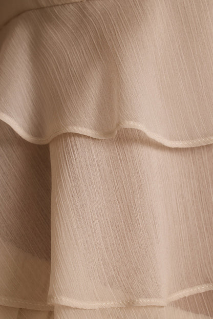 Close-up of tiered ruffles and crinkle texture on the cream Alana resort wear blouse.