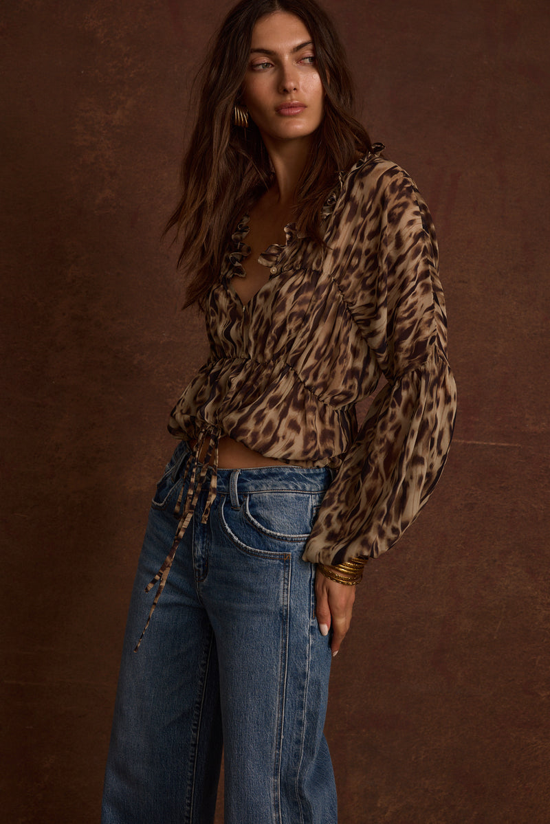 Alba Leopard Chiffon Long Sleeve Blouse paired with complementary accessories for a polished look.