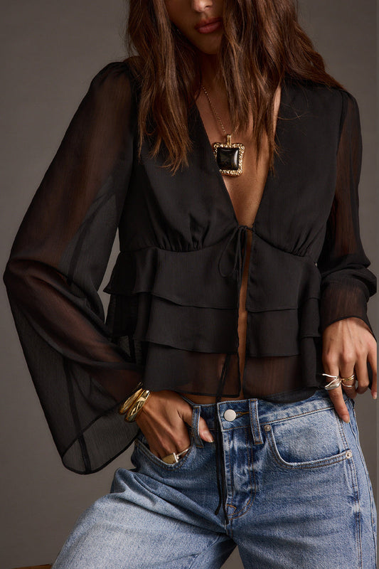 Black blouse with refined detailing and a flattering silhouette.