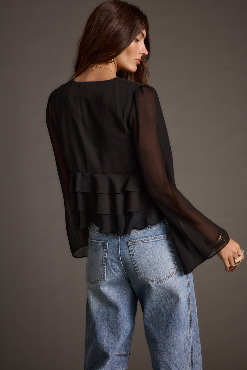 Back view of the black blouse showing the silhouette and fit.