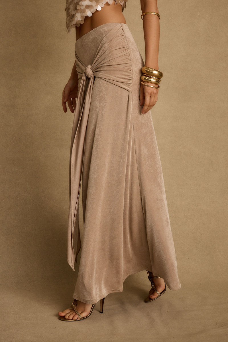 Full-length view of the champagne maxi skirt showing the drape and movement.