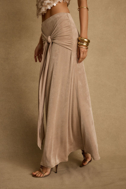 Full-length view of the champagne maxi skirt showing the drape and movement.
