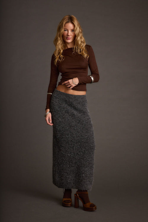 Sweater with elegant accents, a lace maxi skirt essential.