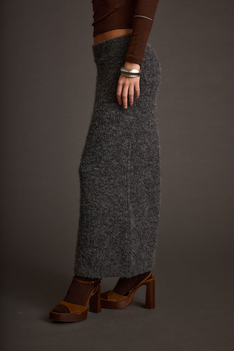 Full-length view of the sweater showing the drape and movement.