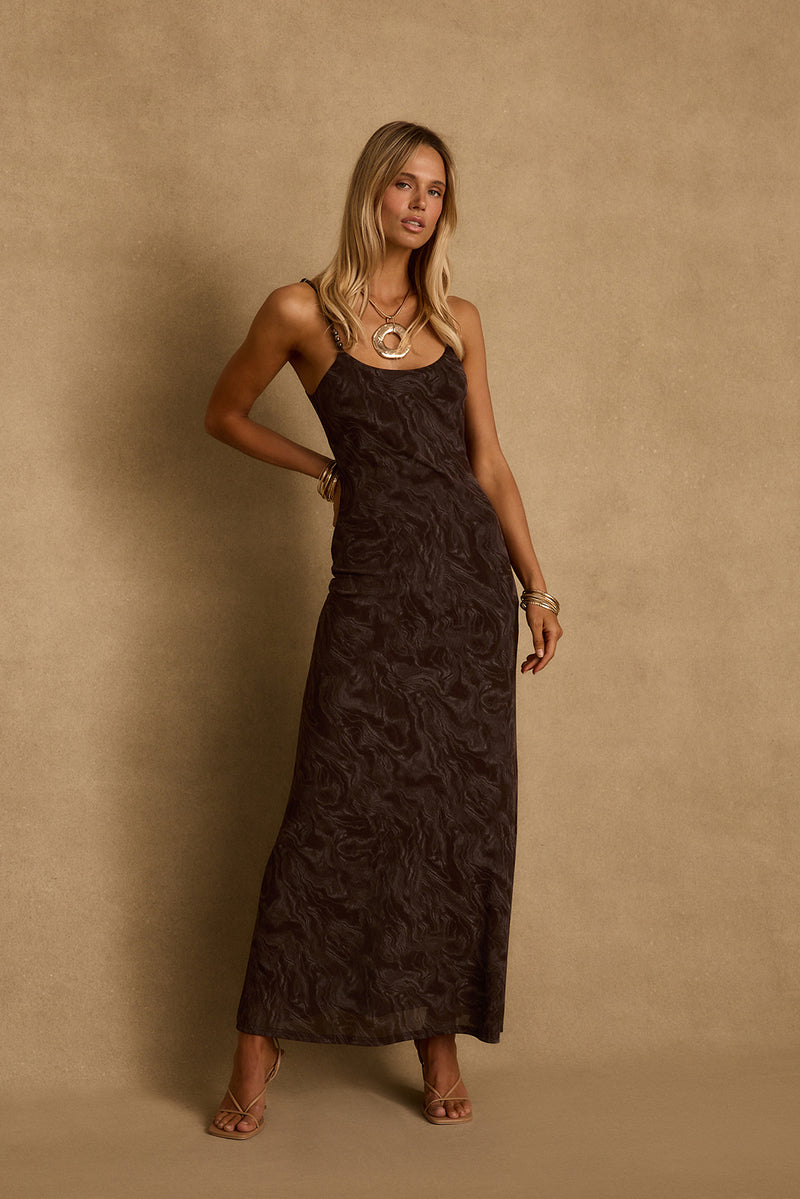 Model in a mocha floral mesh maxi dress with beaded straps and gold jewelry.