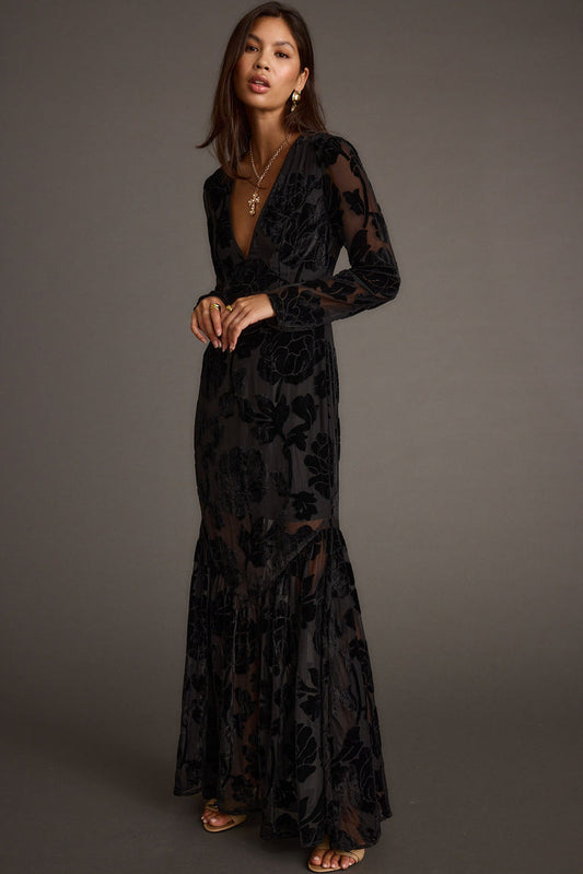 Black velvet maxi dress with refined accents, a vacation maxi dress essential.