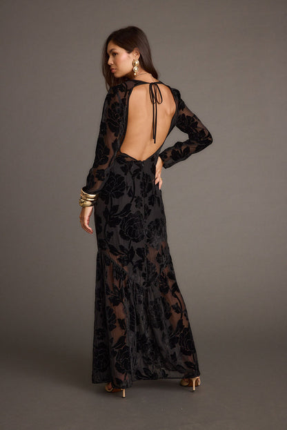 Back view of the black velvet maxi dress showing the silhouette and fit.