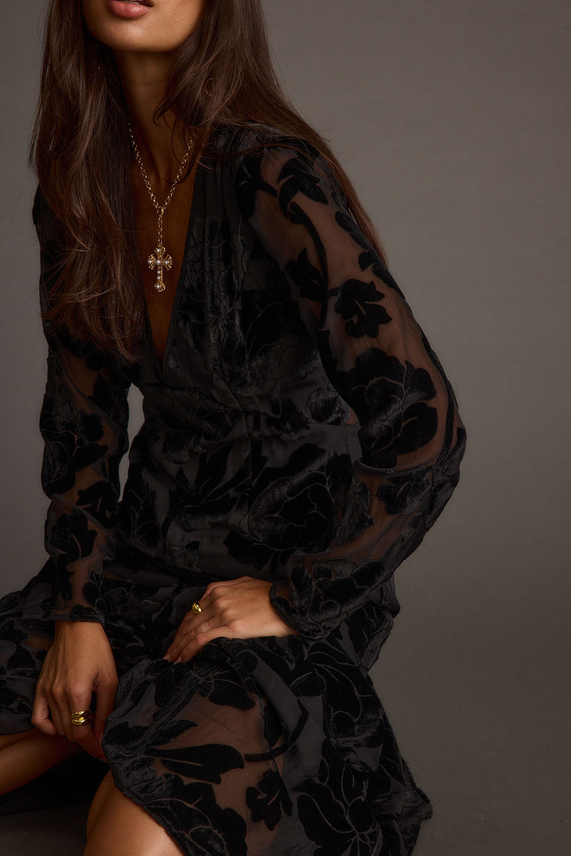 Lifestyle shot of the black maxi dress styled for day-to-night versatility.