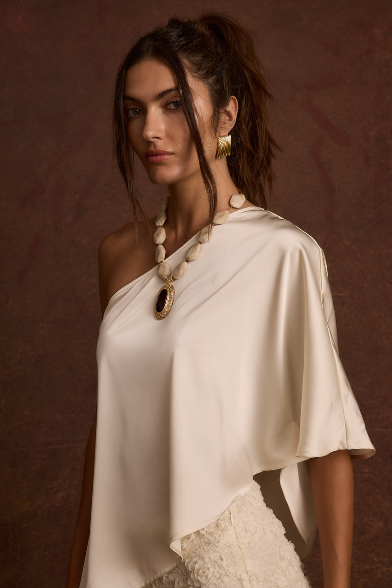 Anya Ivory One Shoulder Top paired with complementary accessories for a polished look.