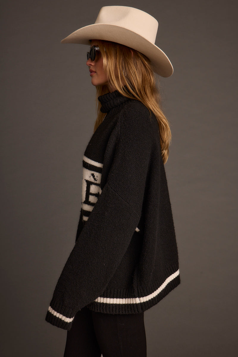 Apres Black and White Turtleneck Sweater paired with complementary accessories for a polished look.