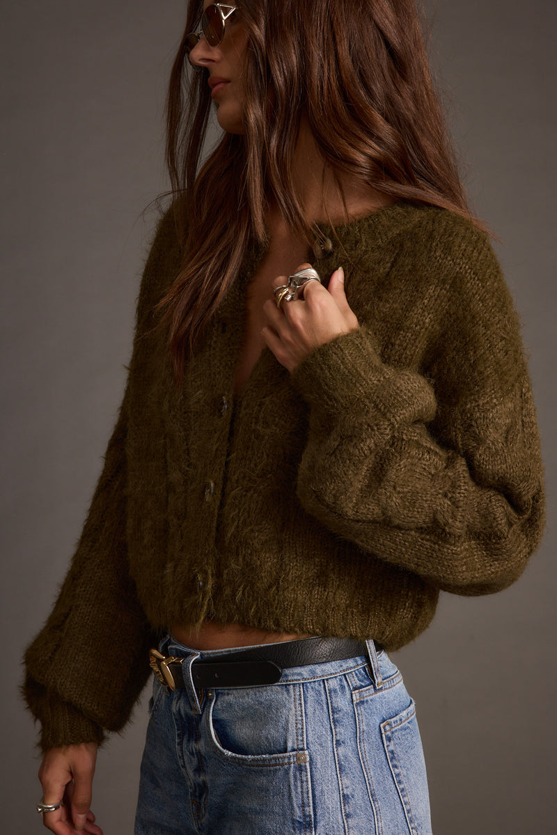 Close-up of the Archie Olive Cropped Cardigan showcasing the fabric texture and design details.