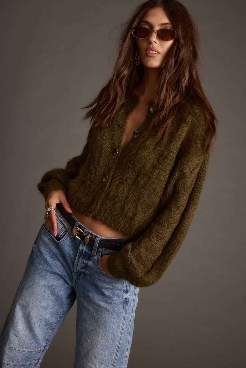 Detail shot of the Archie Olive Cropped Cardigan highlighting the cropped elements.