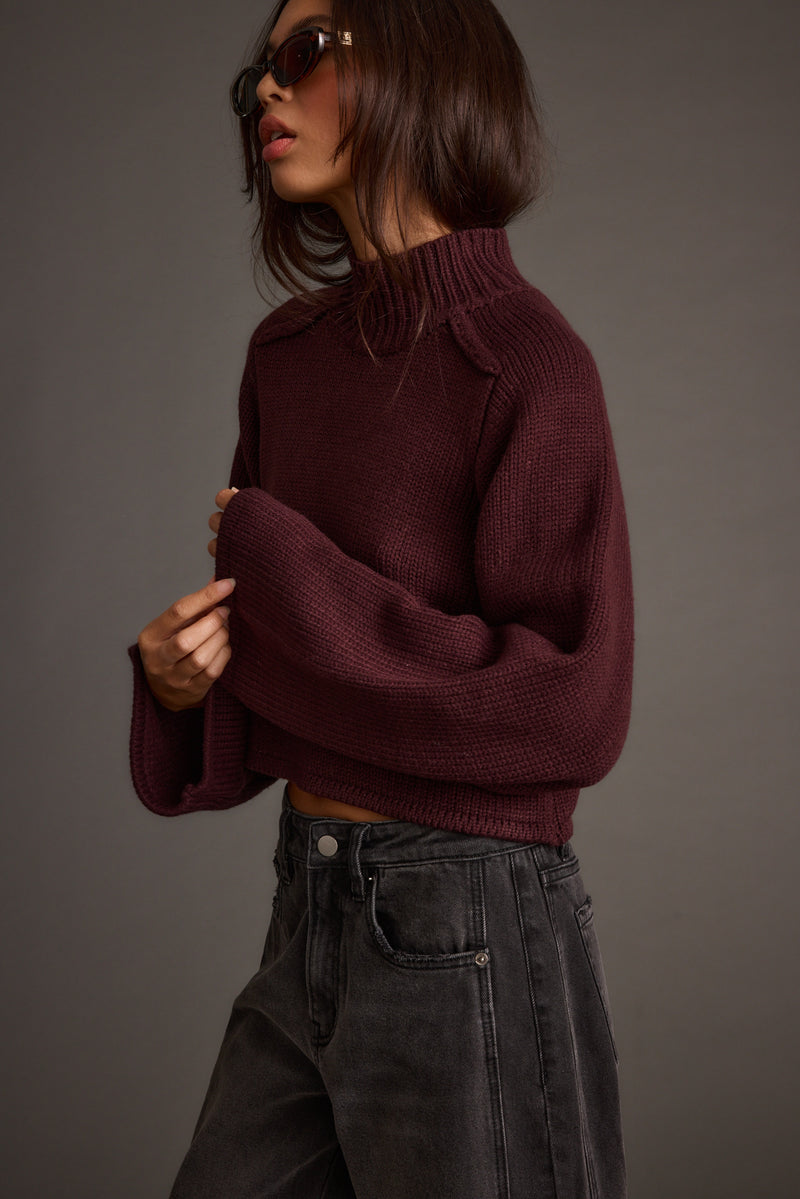 Back view of the plum sweater showing the silhouette and fit.