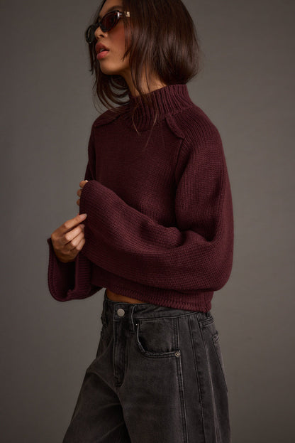 Back view of the plum sweater showing the silhouette and fit.