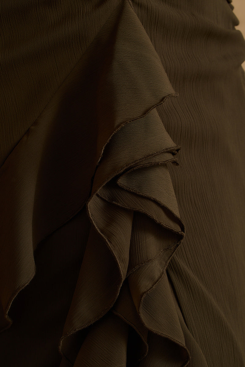 Close-up of cascading ruffle detail on the olive Aria halter maxi dress skirt.