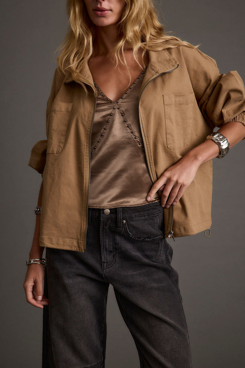 Lifestyle shot of the tank top styled for day-to-night versatility.