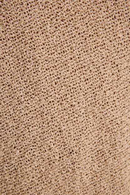Close-up of stretchy metallic gold knit fabric used for the Avaiana festival shorts.