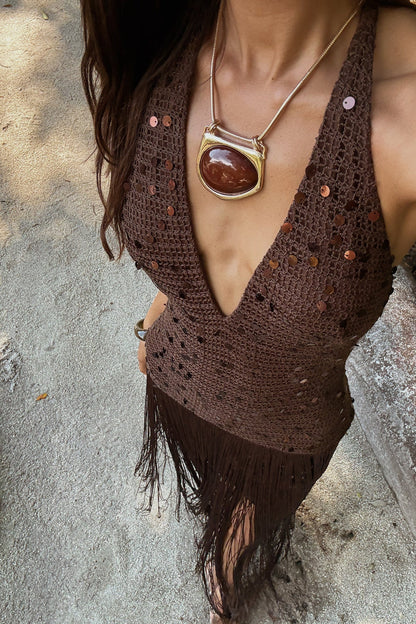 Woman in a long, dark brown fringe dress