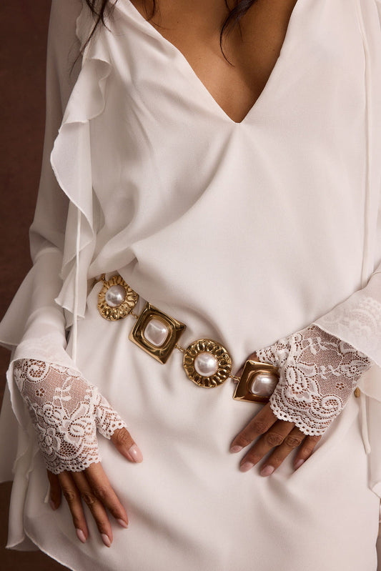 Pearl belt with refined accents, a pearl chain belt essential.