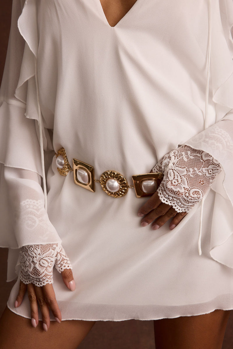 Full-length view of the white piece showing the drape and movement.