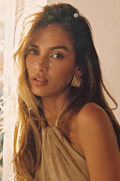 Gold earrings with refined detailing and an elegant finish.