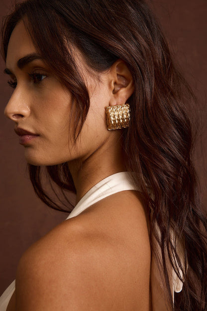 Calaia Gold Earrings shown from a different angle, highlighting the metalwork details.