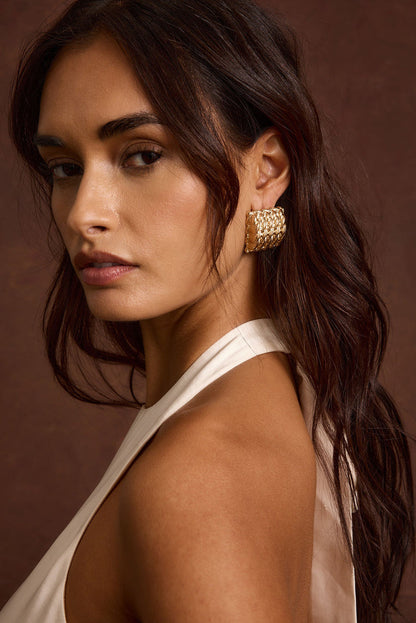 Close-up of the Calaia Gold Earrings showcasing the metalwork and pendant detail.