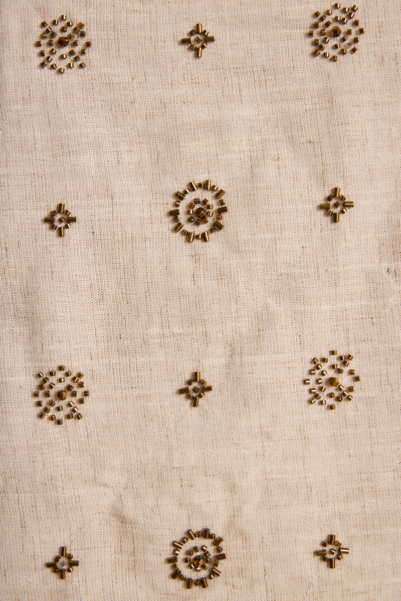 Gold beaded flower motifs scattered across the natural linen Camila tank fabric.
