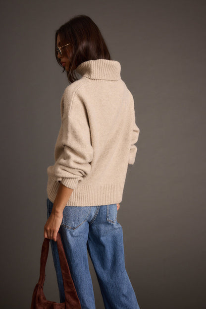 Close-up of the Cedar Oatmeal Oversized Sweater Turtleneck showcasing the fabric texture and design details.
