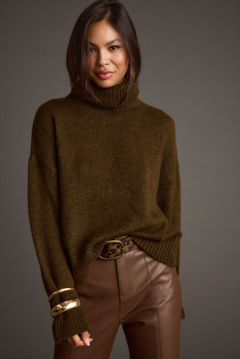 Full-length view of the sweater showing the drape and movement.