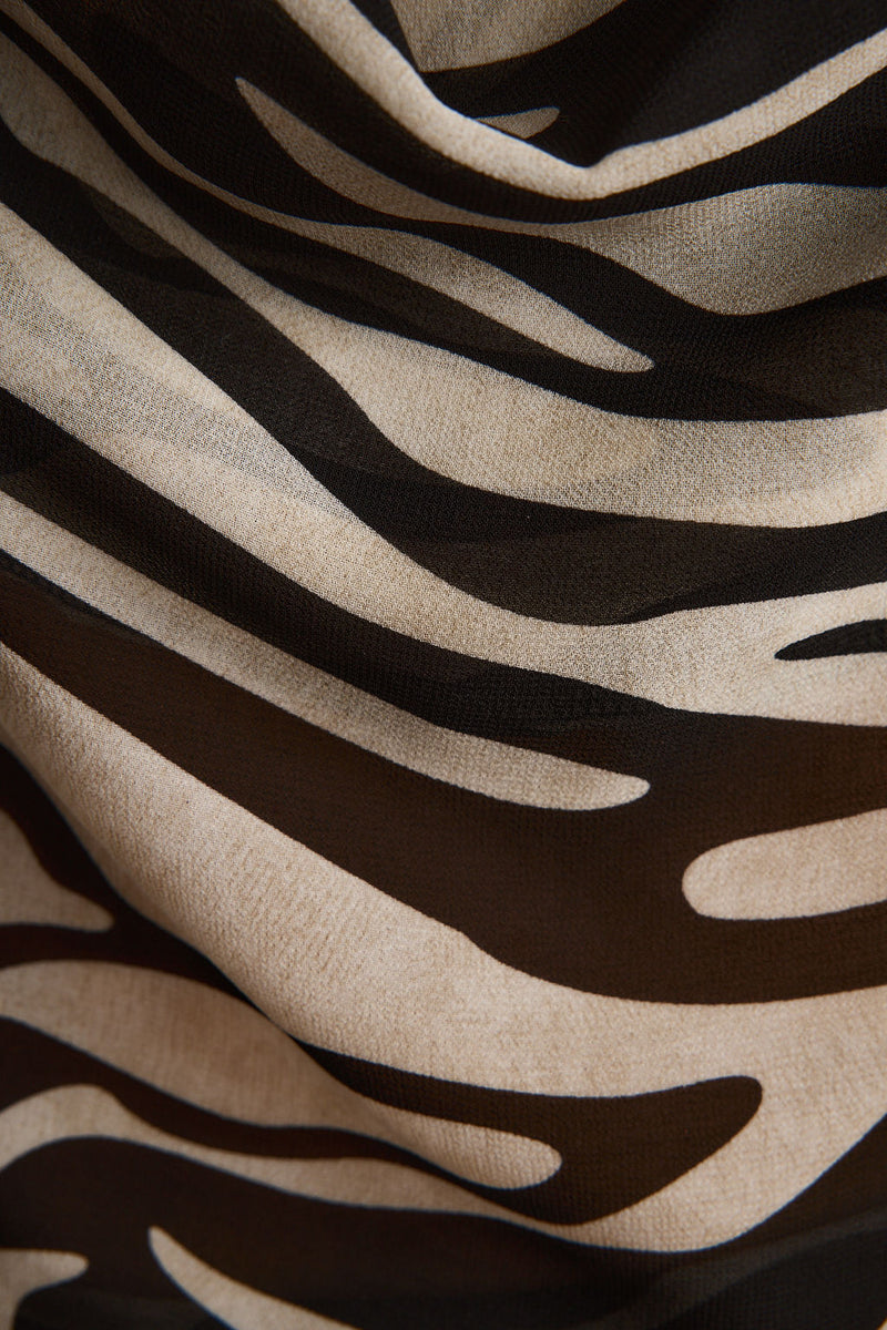 Lifestyle shot of the zebra print piece styled for day-to-night versatility.