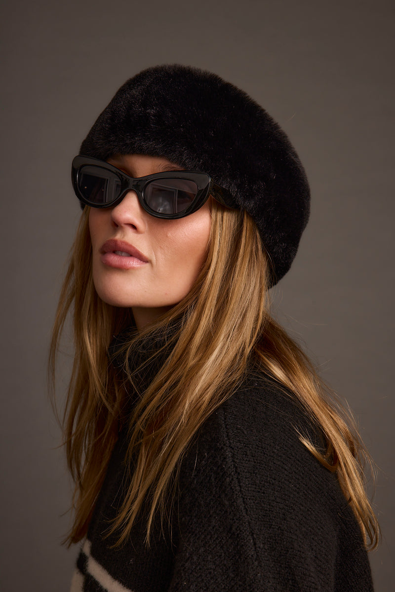 Black faux fur hat with refined accents, a black fur hat essential.