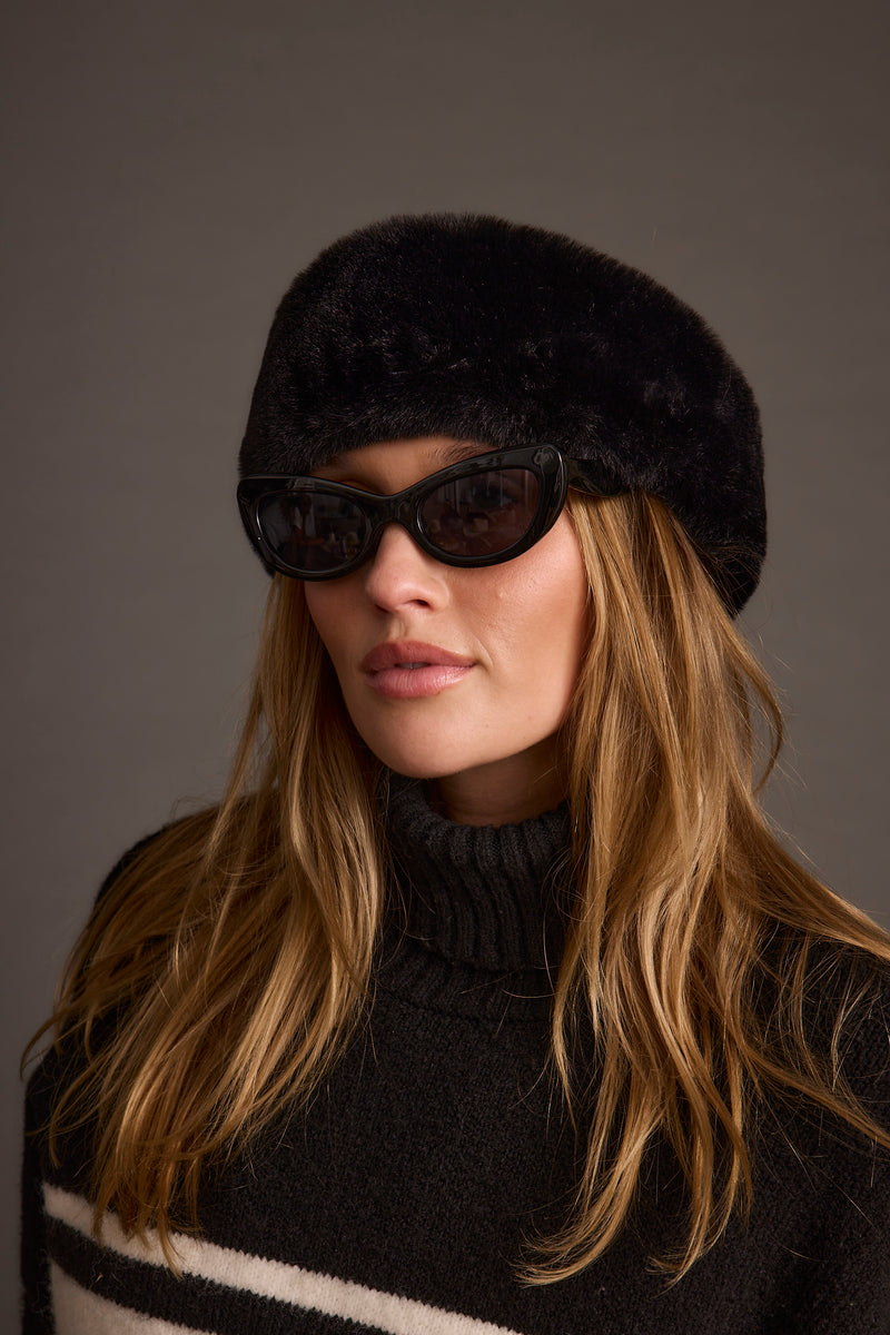 Chalet Black Faux Fur Headband shown as part of a styled outfit ensemble.