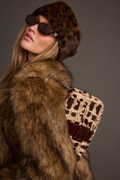 Leopard print faux fur hat with refined detailing and a flattering silhouette.