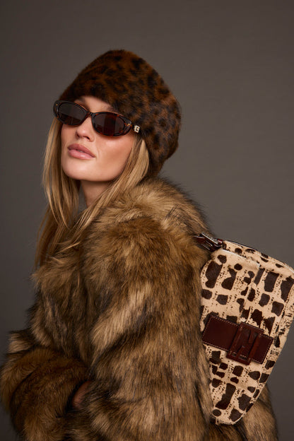 Chalet Leopard Faux Fur Headband shown as part of a styled outfit ensemble.