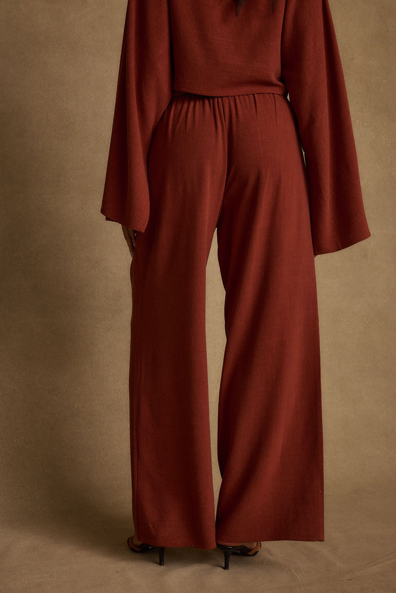 Detail shot of the Clear Breeze Rust Linen Pants highlighting the linen elements.