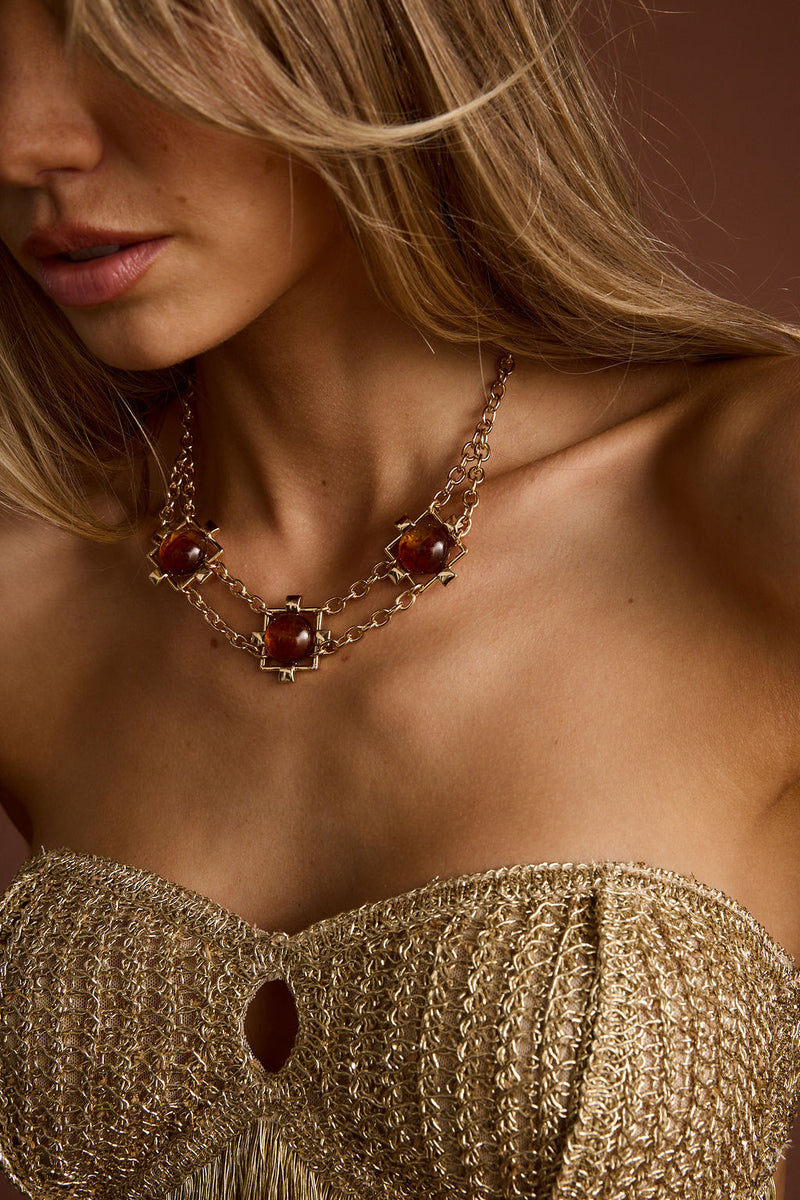 Close-up of the Coralli Amber Stone Choker showcasing the fabric texture and design details.