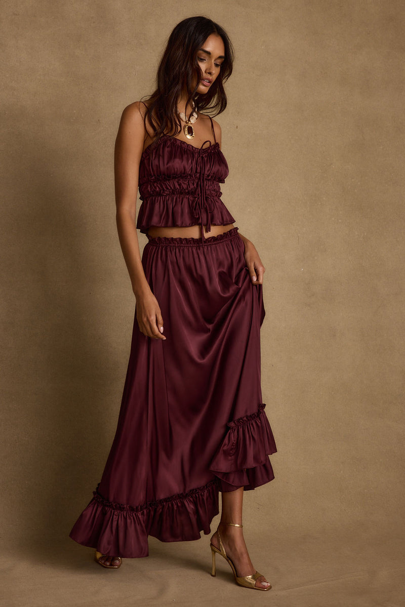 Dahlia Mulberry Satin Maxi Skirt paired with complementary accessories for a polished look.