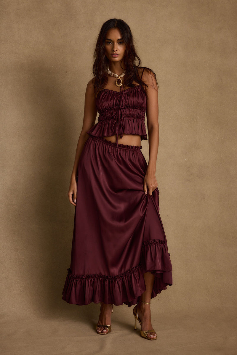 Detail shot of the Dahlia Mulberry Satin Maxi Skirt highlighting the satin elements.