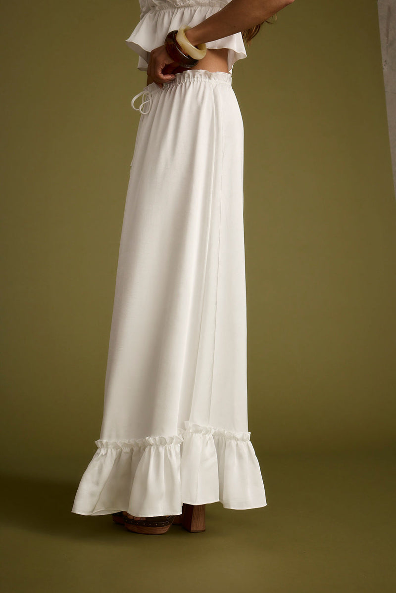 Lifestyle shot of the white maxi skirt styled for day-to-night versatility.