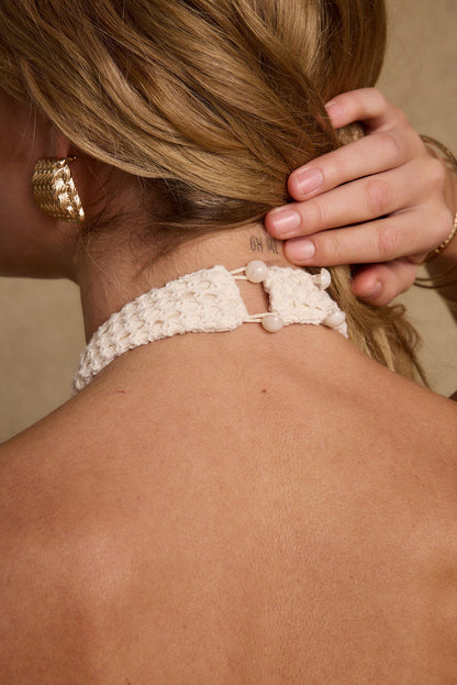 Daya Ivory Shell Embellished Halter Top paired with complementary accessories for a polished look.