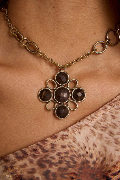 Delphine Gold Pendant Necklace shown from a different angle, highlighting the metalwork details.