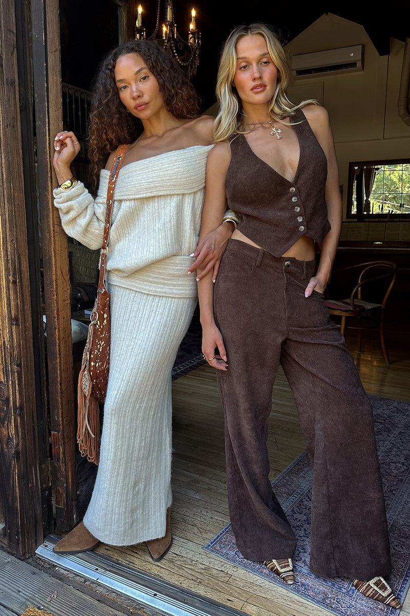 Model in brown corduroy wide-leg trousers paired with a matching button-front corduroy vest.