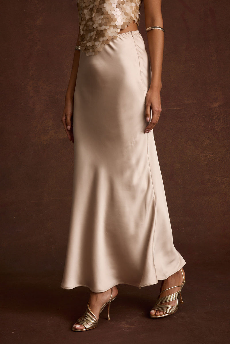 Dolce Champagne Satin Maxi Skirt paired with complementary accessories for a polished look.